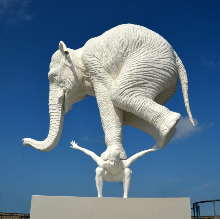 statue of elephant on the back of a man to symbolize not carrying the weight of your business alone